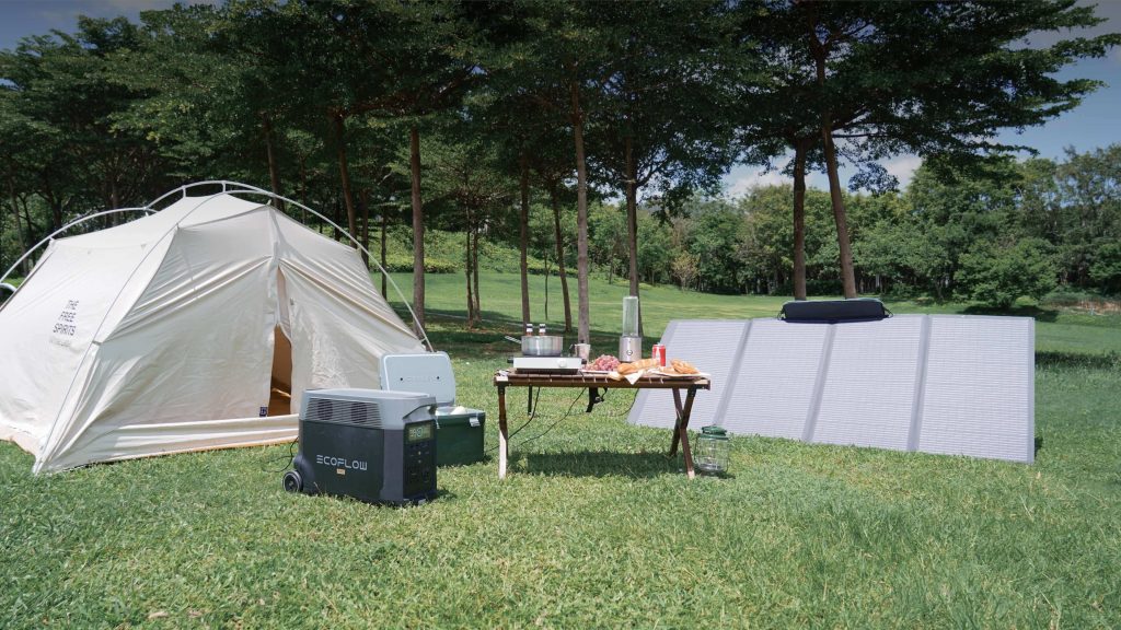 EcoFlow 400W Solar Panel - a panel at a campsite next to an EcoFlow station