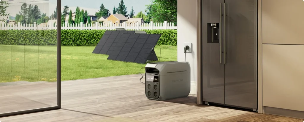 An EcoFlow DELTA 3 Plus by a fridge charging from a socket and a solar panel at the same time