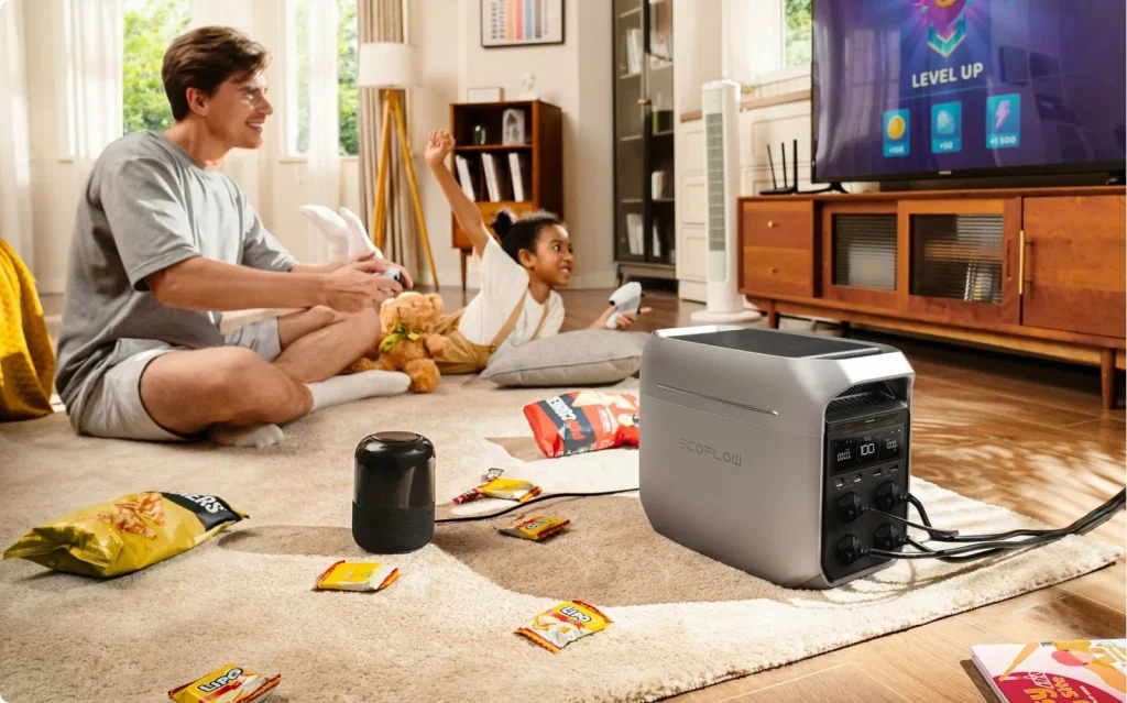 An EcoFlow DELTA 3 Plus in a living room powering a TV and a speaker while the family relaxes on the carpet