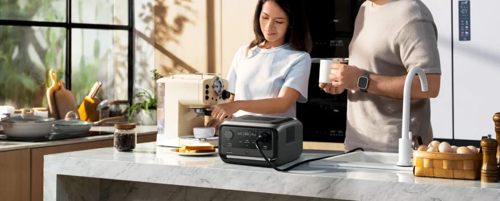 An EcoFlow RIVER 3 Plus Wireless on a kitchen counter powering a coffee maker through a Schuko outlet